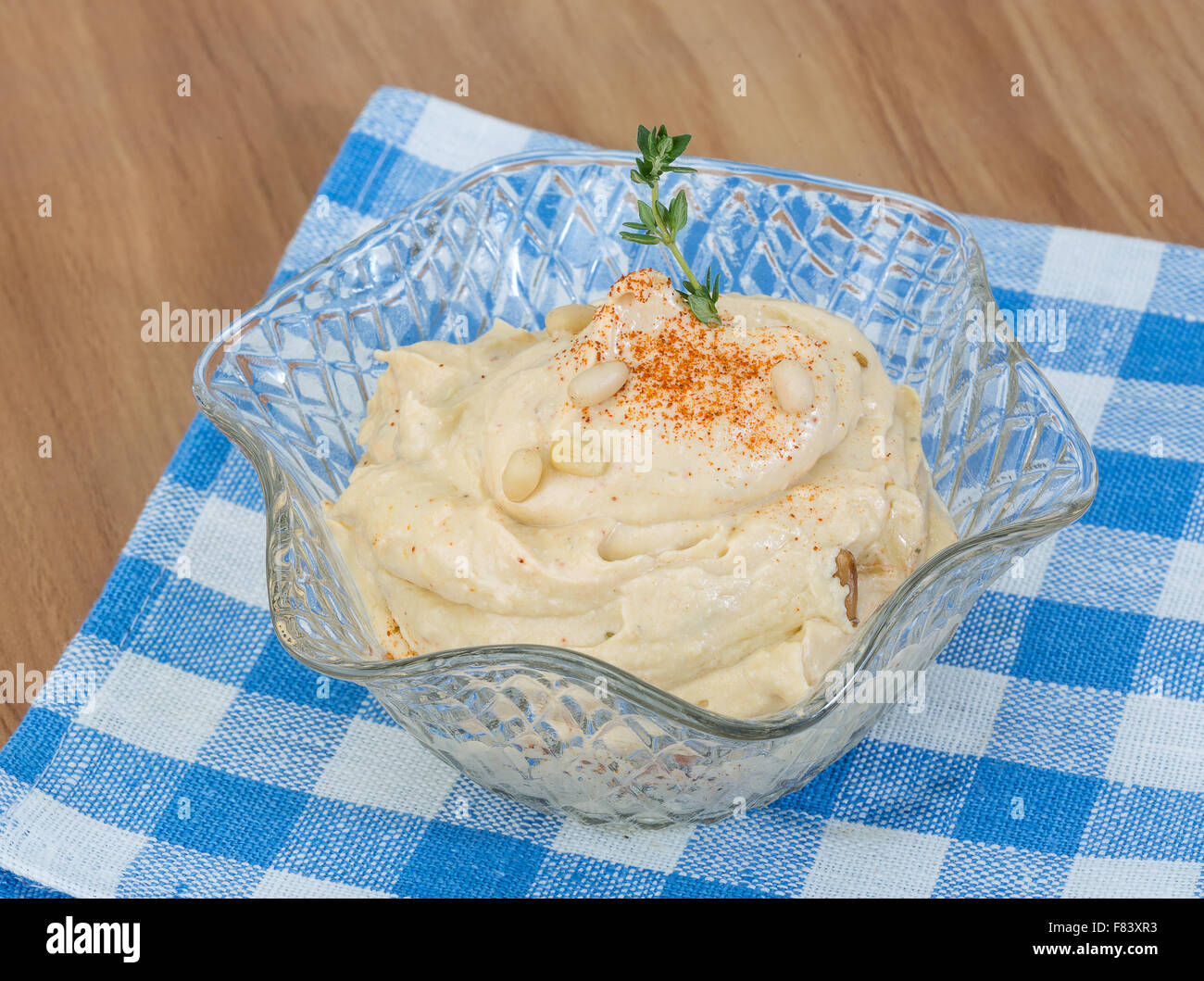 Hummus in the bowl with paprica and cedar nut Stock Photo Alamy