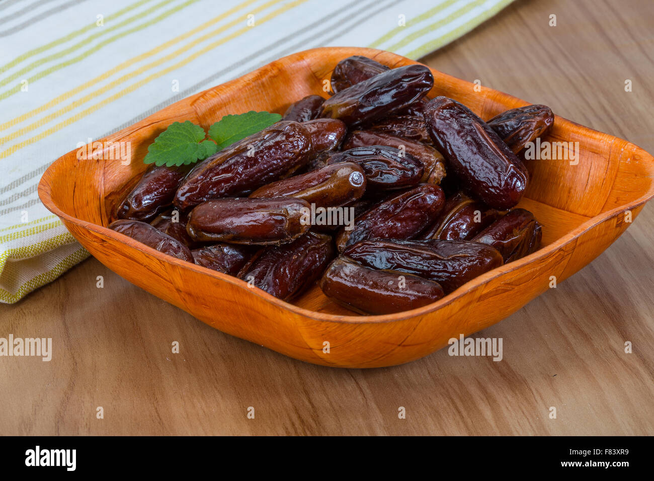 Dry Dates fruit in the bowl on the wood background Stock Photo Alamy