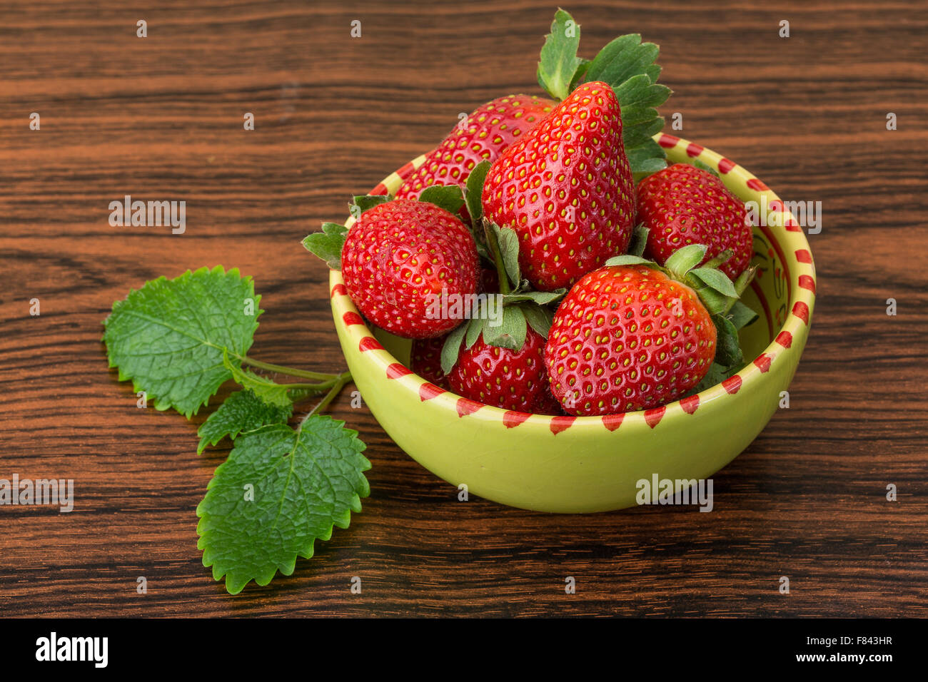 Fresh ripe strawberries in the bowl on wooden background Stock Photo ...
