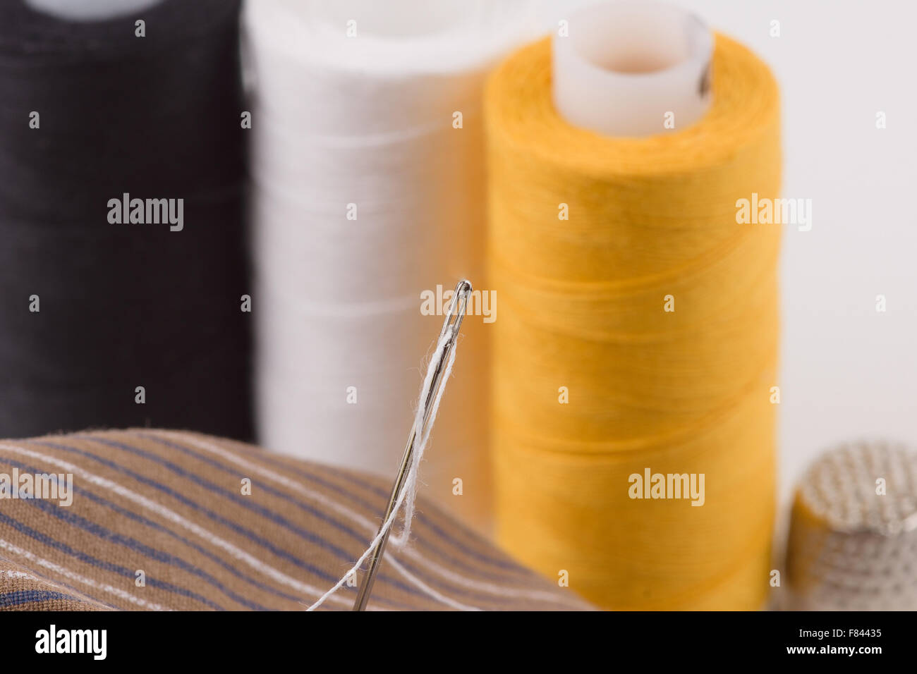 we sew buttons a sharp needle with a thread Stock Photo