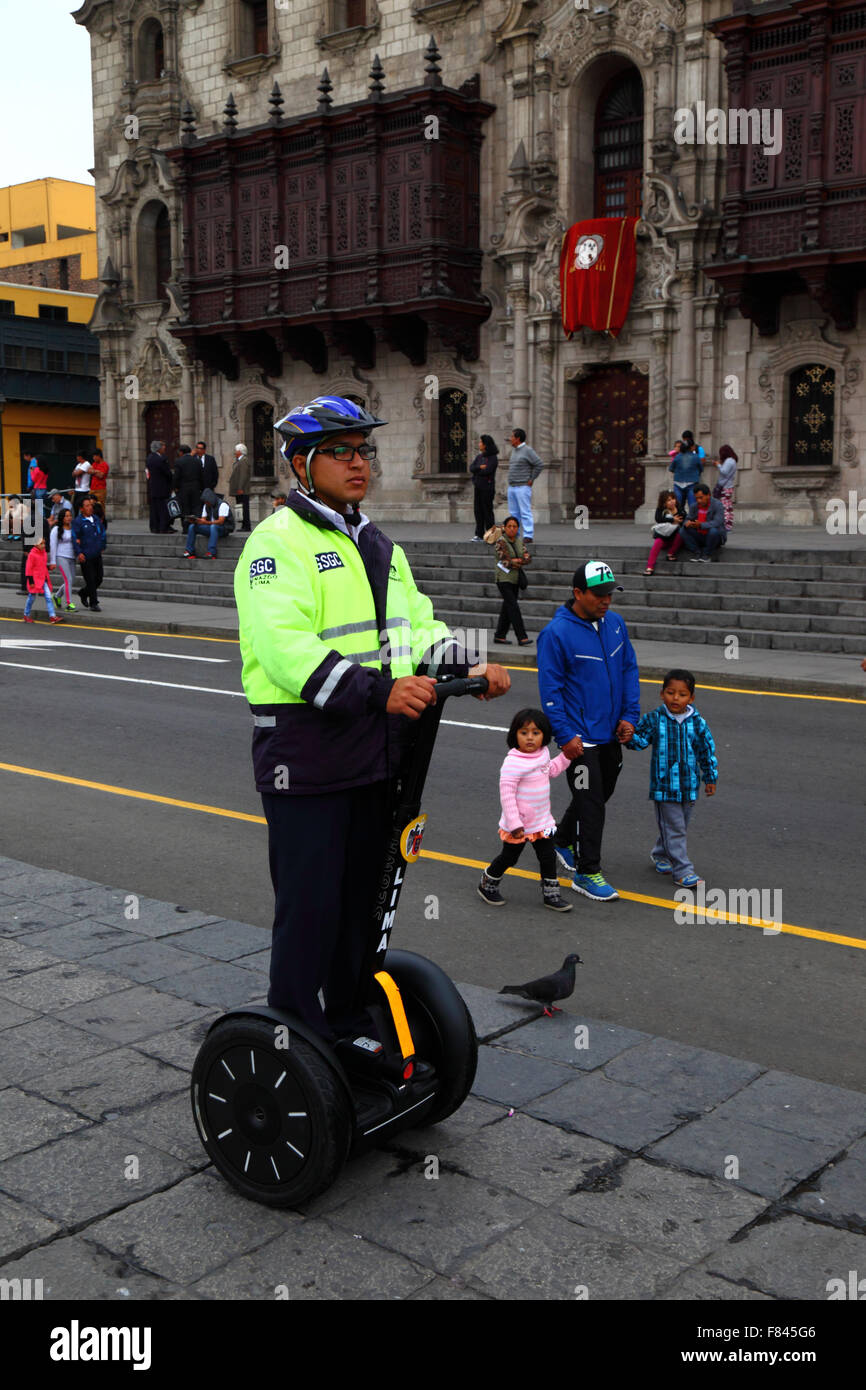 Serenazgo municipal security guard riding on a Segway Personal Transporter in front of Archbishop's Palace, Plaza de Armas, Lima, Peru Stock Photo