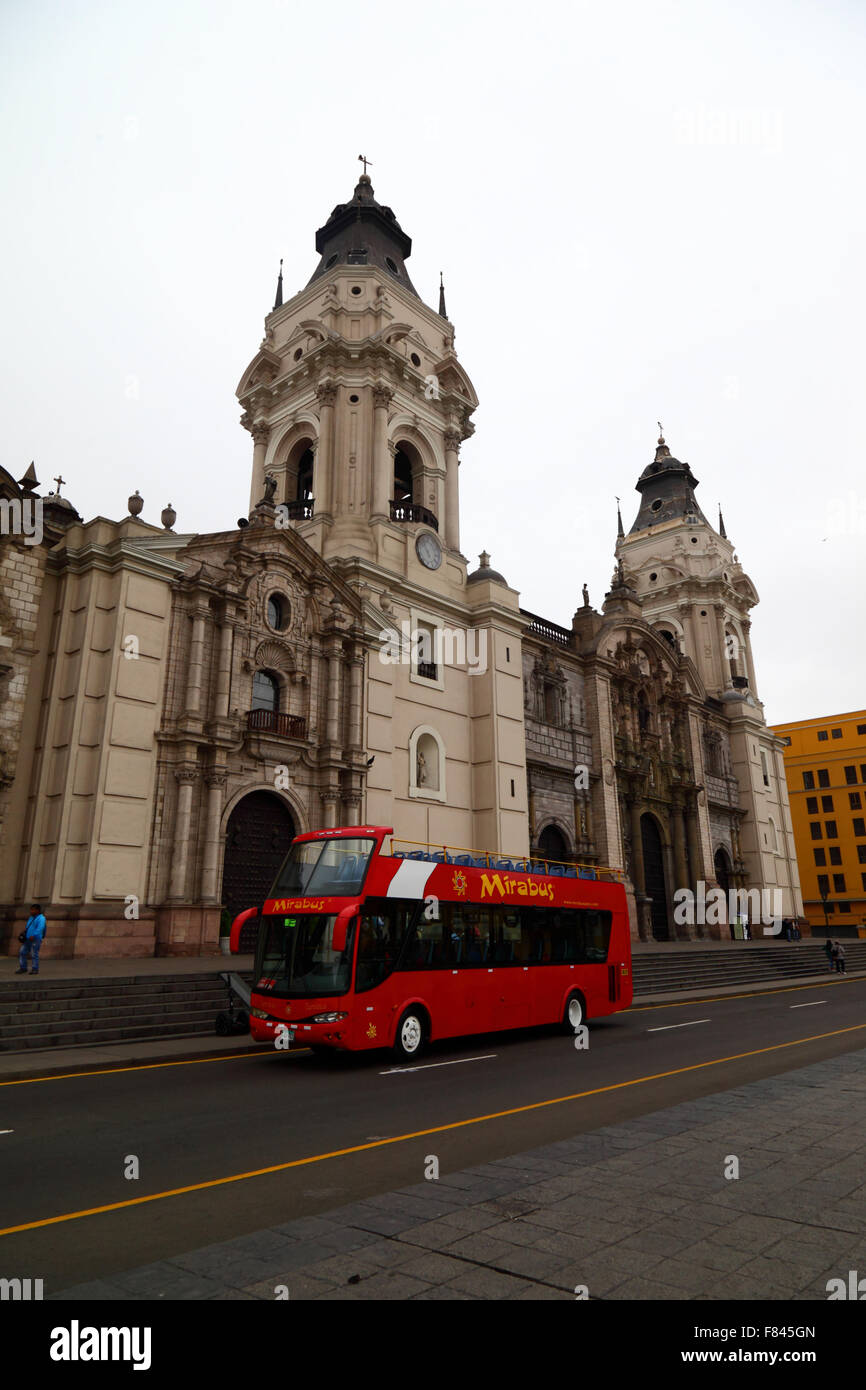 Open topped double decker sightseeing tour bus in front of cathedral, Plaza de Armas , Lima , Peru Stock Photo