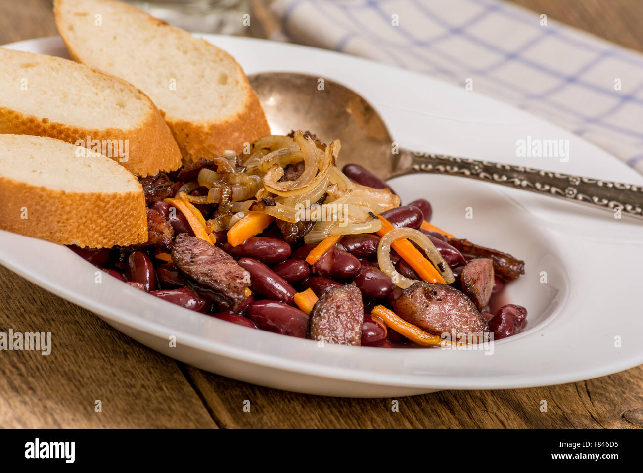 Traditional red beans with sausage and vegetables and baquette Stock Photo