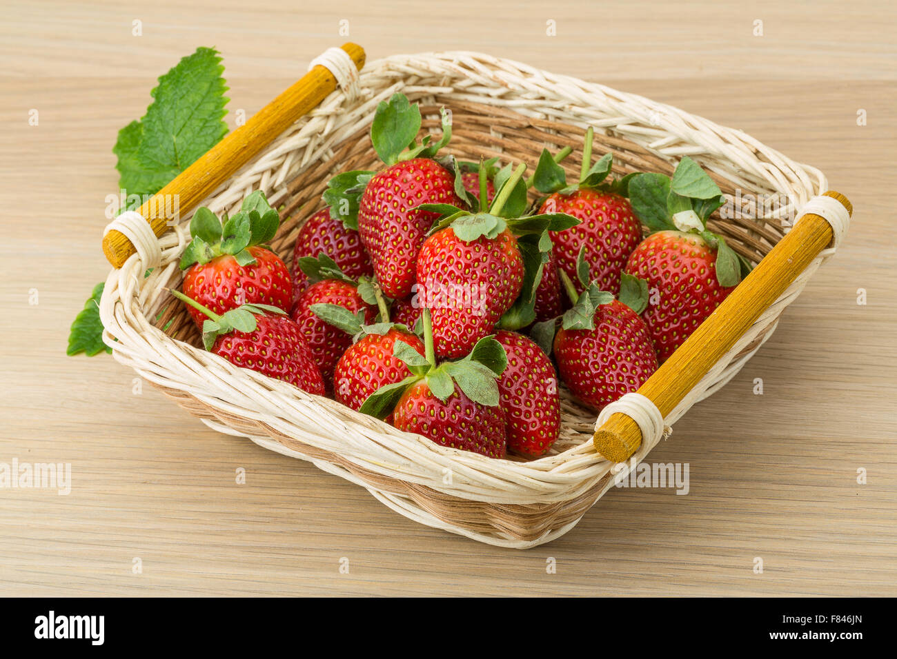 Fresh ripe strawberries in the bowl on wooden background Stock Photo ...