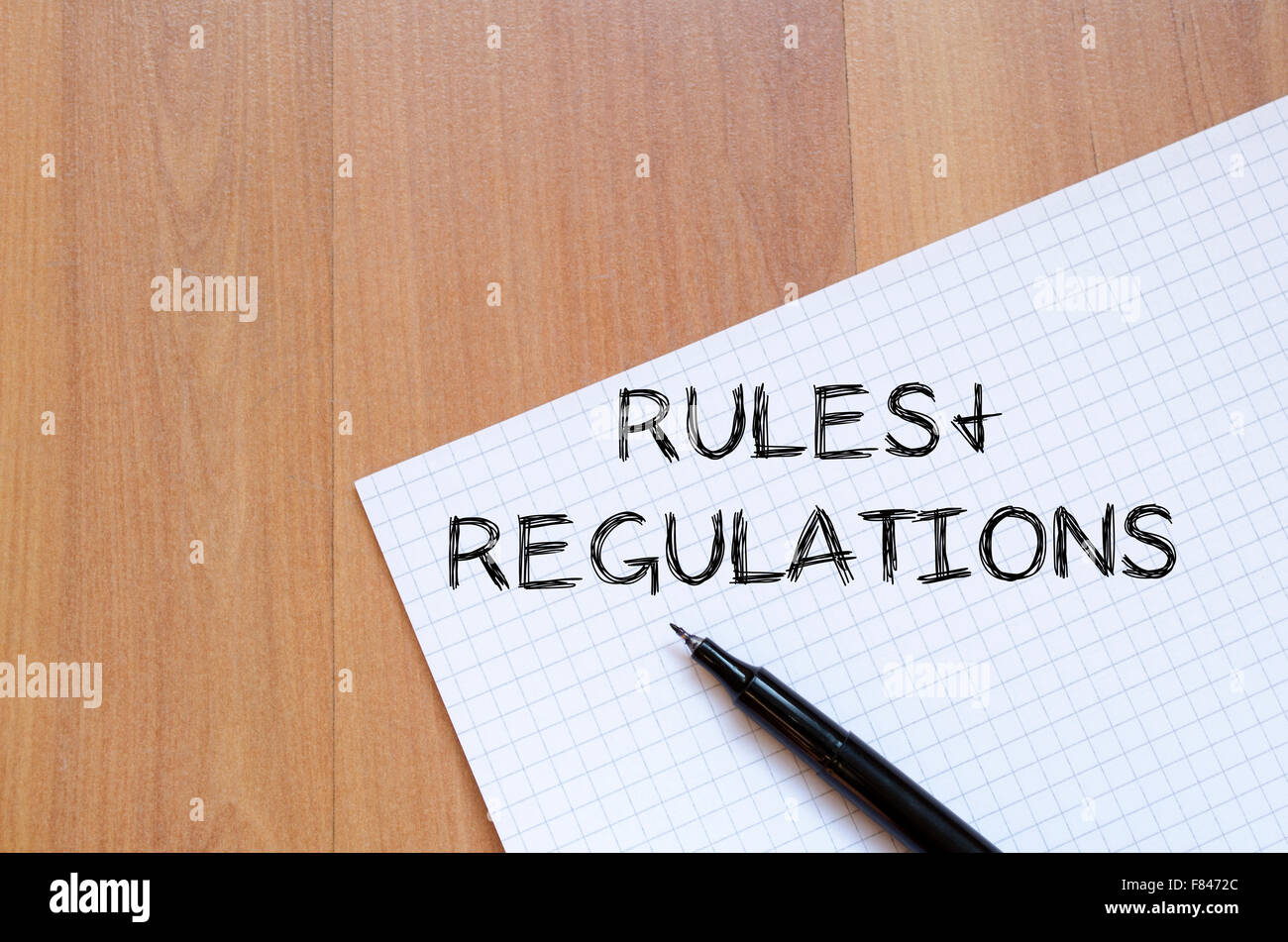 Rules and regulations text concept write on notebook with pen stock