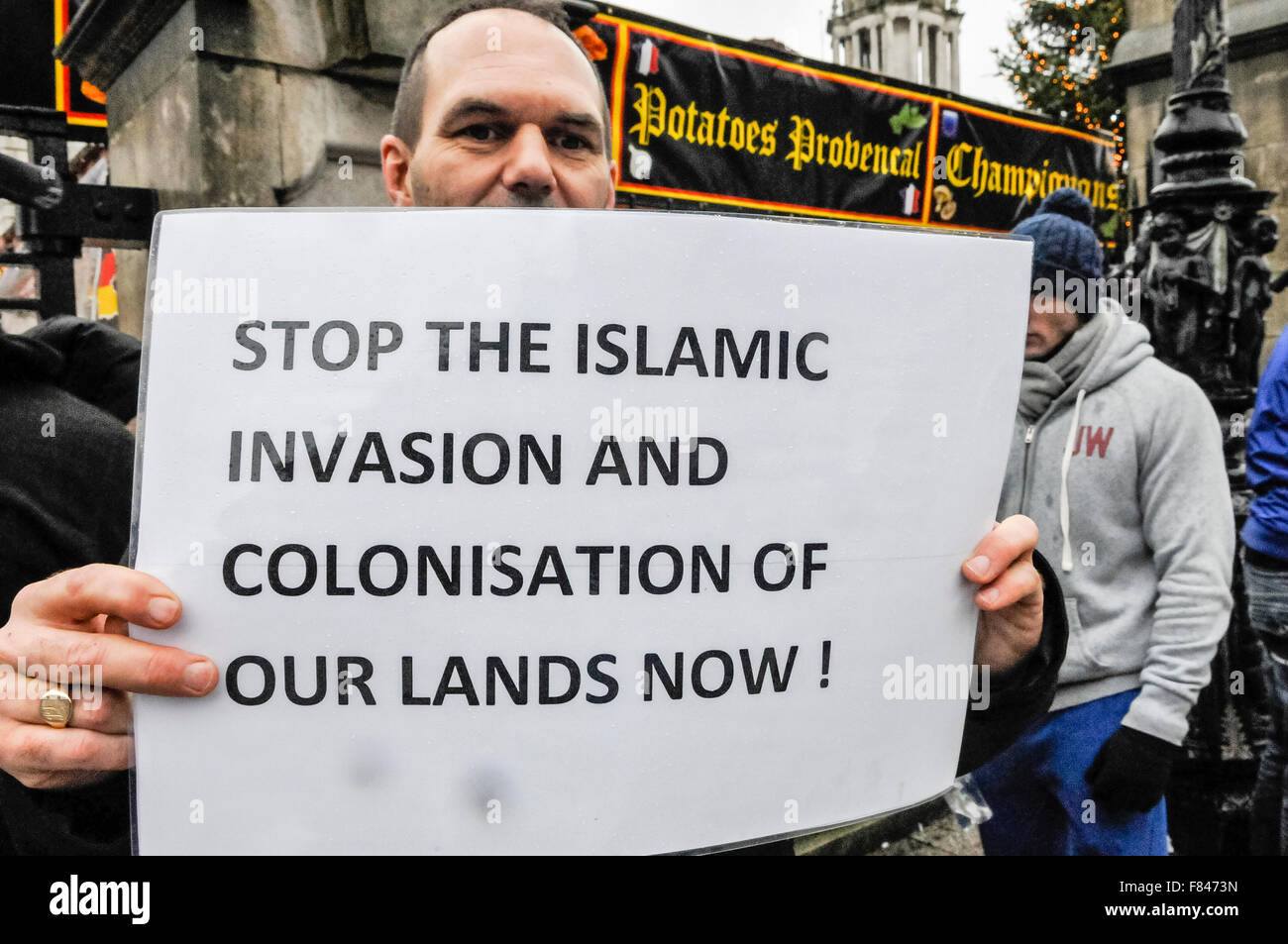 Belfast, Northern Ireland. 05 Dec 2015 - A man holds a poster with the message 'Stop the Islamic invasion and colonisation of our lands now!'. Credit:  Stephen Barnes/Alamy Live News Stock Photo