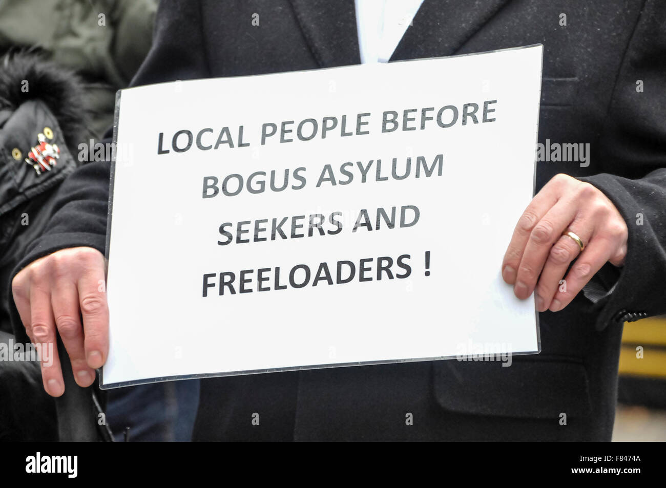 Belfast, Northern Ireland. 05 Dec 2015 - A man holds a poster saying 'Local people before bogus asylum seekers and freeloaders!' as the Protestant Coalition hold a protest against Islamic refugees coming to Northern Ireland. Credit:  Stephen Barnes/Alamy Live News Stock Photo