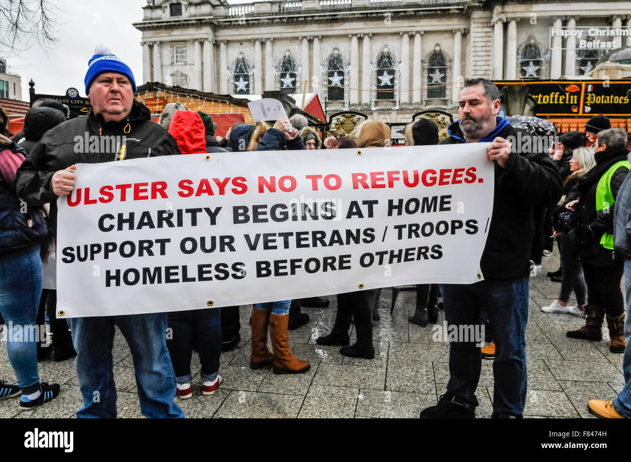 Belfast, Northern Ireland. 05 Dec 2015 - Protestant Coalition supporters hold banner which says 'Ulster says no to refugees.  Charity begins at home.  Support our veterans/troops/homeless before others' at a protest against Islamic refugees coming to Northern Ireland. Credit:  Stephen Barnes/Alamy Live News Stock Photo