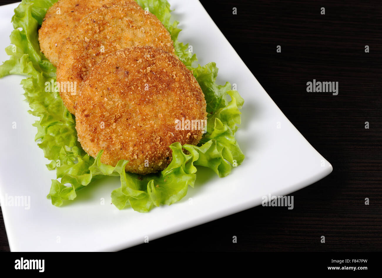 Chicken cutlet breaded in lettuce leaves Stock Photo