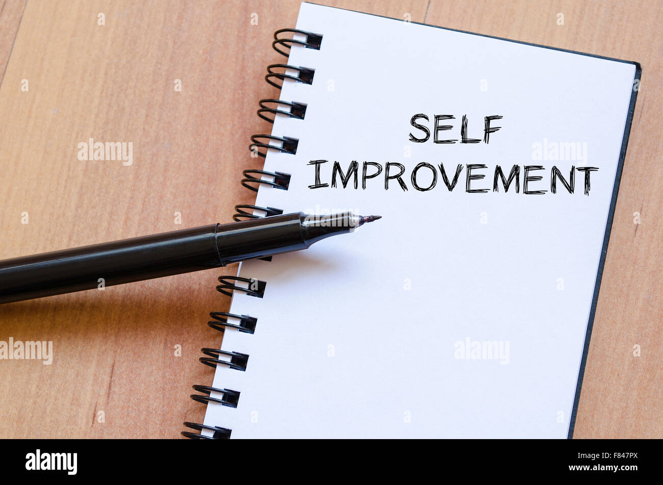 Self improvement text concept write on notebook with pen Stock Photo