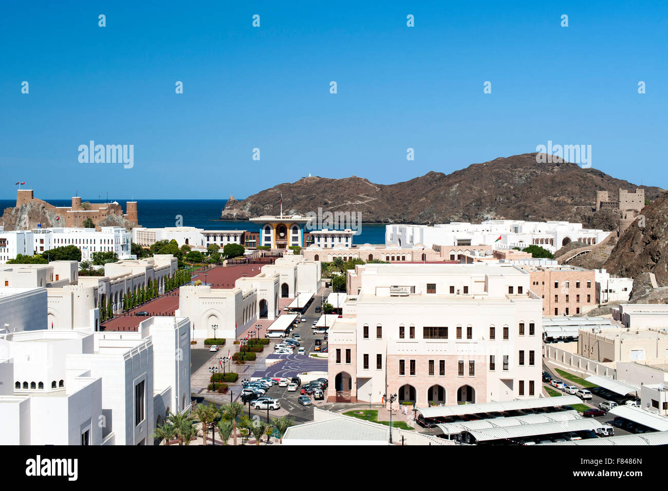 View of Al Mirani fort, Al Alam palace and government buildings in Old Muscat, part of the capital of the Sultanate of Oman. Stock Photo