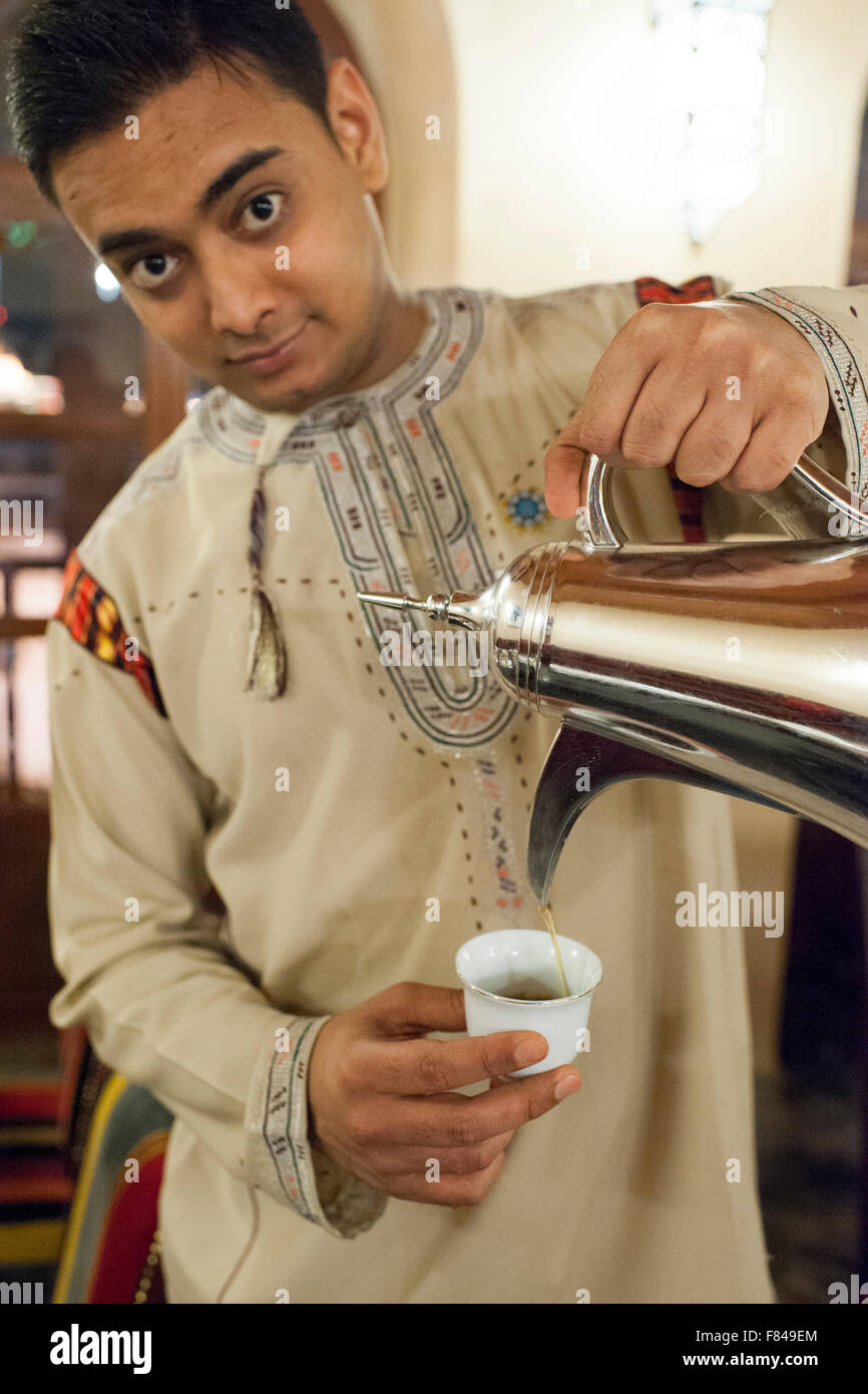 A waiter pouring coffee in the Bait Al Luban restaurant in Muscat, the capital of the Sultanate of Oman. Stock Photo