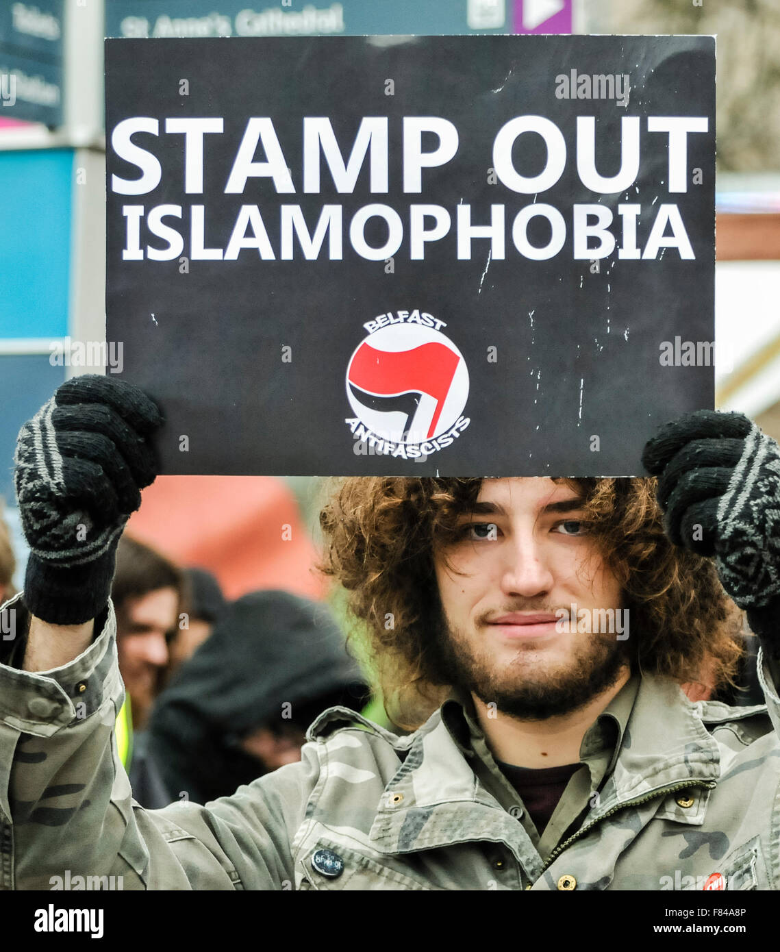 Belfast, Northern Ireland. 05 Dec 2015 - A man holds a sign saying 'Stamp Out Islamophobia' at a pro-refugee gathering to protest against the Protestant Coalition's anti-refugee rally. Credit:  Stephen Barnes/Alamy Live News Stock Photo