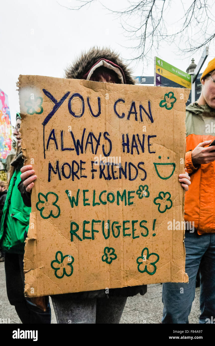 Belfast, Northern Ireland. 05 Dec 2015 - Pro-refugee supporter holds up a sign saying 'you can always have more friends. Welcome Refugees!' at a protest rally. Credit:  Stephen Barnes/Alamy Live News Stock Photo