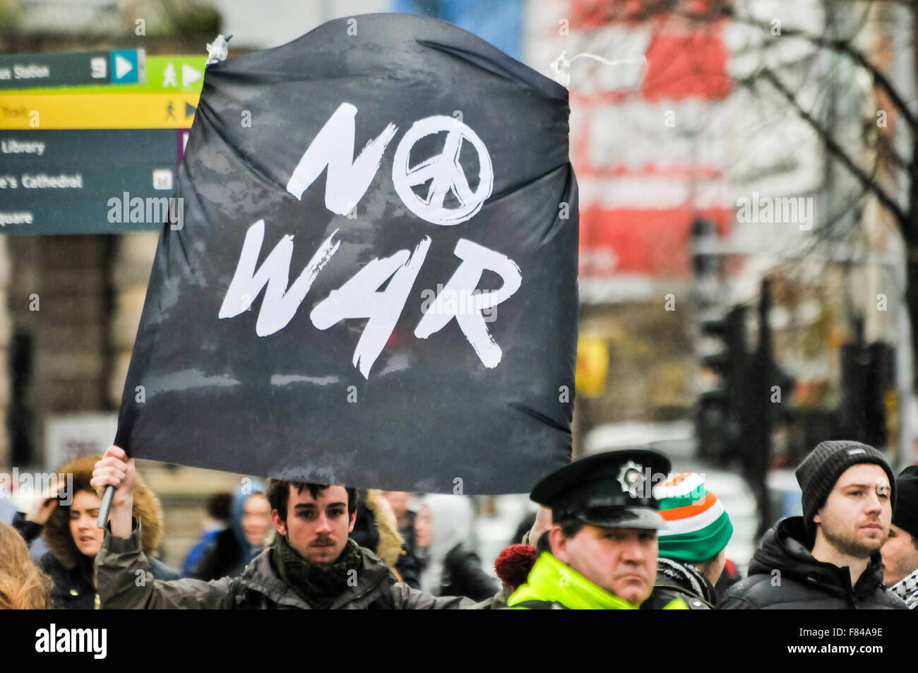 Belfast, Northern Ireland. 05 Dec 2015 - A man holds up a banner which says 'No War' (with the CND symbol) at a protest rally  Credit:  Stephen Barnes/Alamy Live News Stock Photo