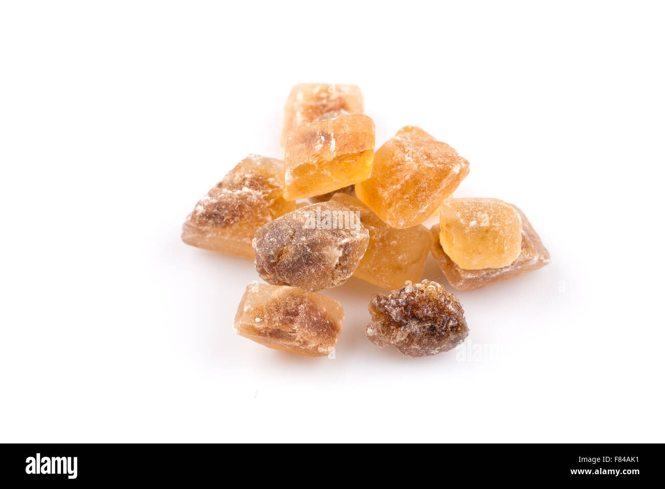 Brown caramelized lump cane sugar cube isolated on white background