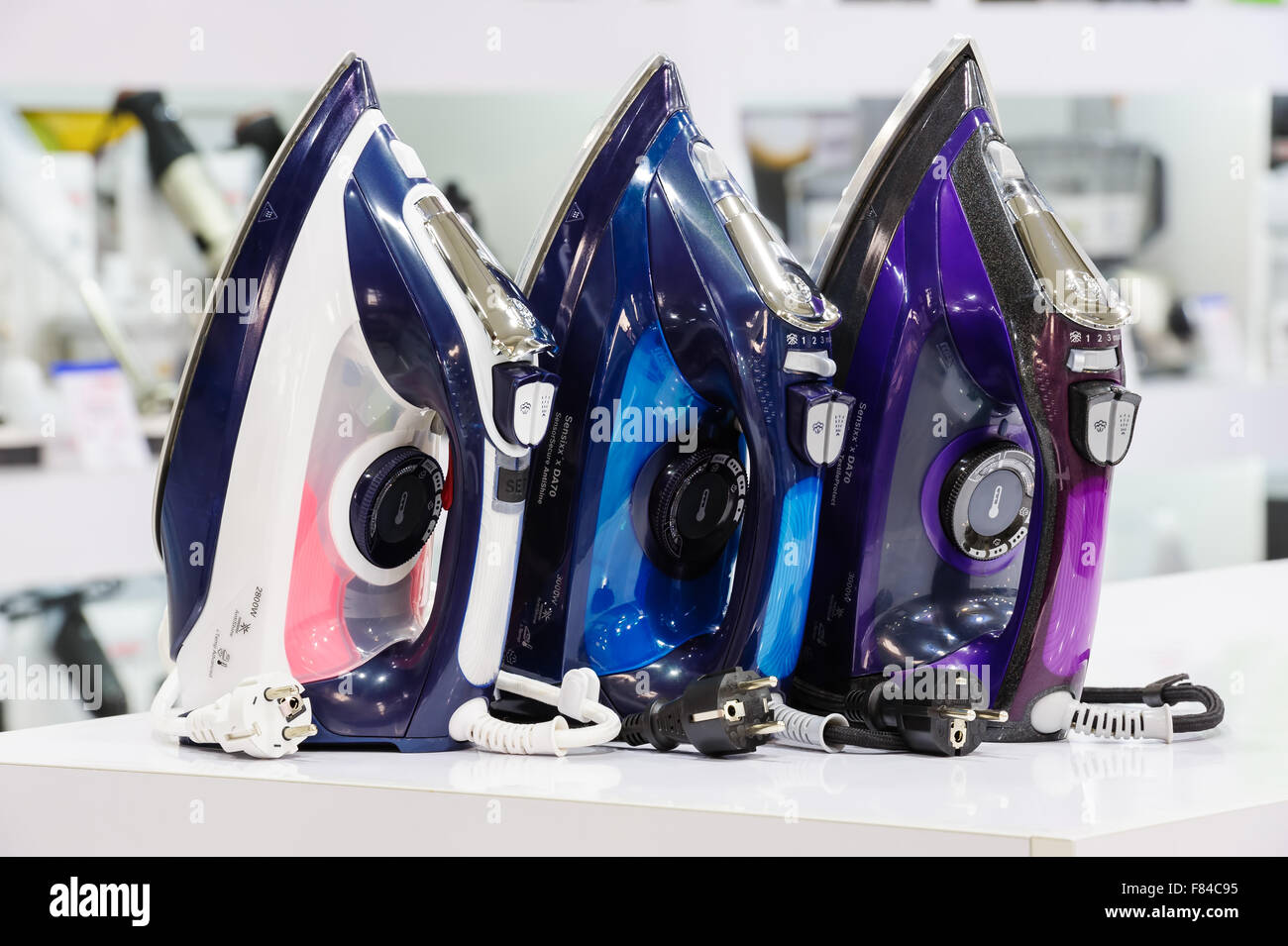three electric irons in retail store Stock Photo Alamy