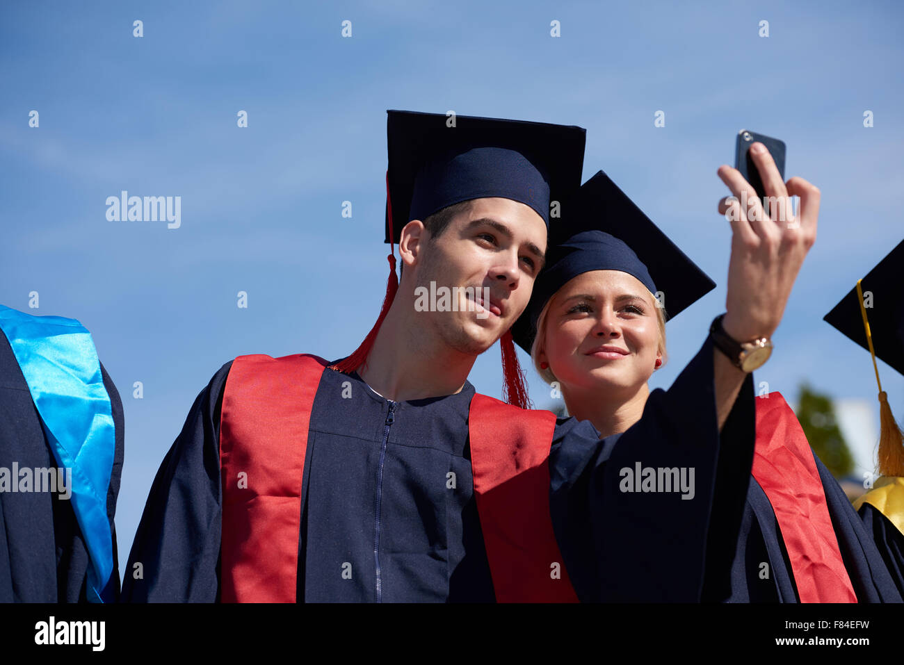 Capturing a happy moment.Students group college graduates in graduation ...
