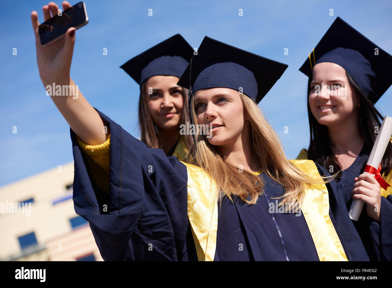 Capturing a happy moment.Students group college graduates in graduation ...