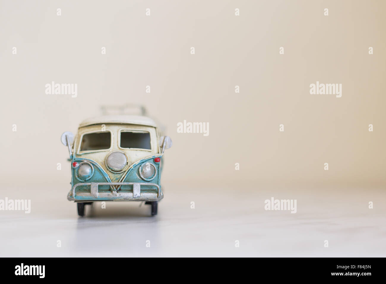 Close up detailed front view of white and blue vintage travel bus toy. Stock Photo