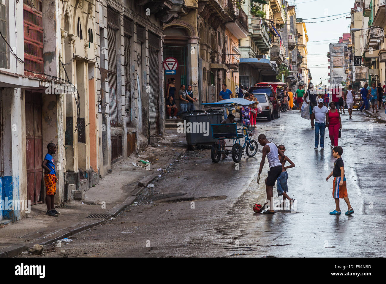 Four boys playing football on the streets of Havana. Stock Photo