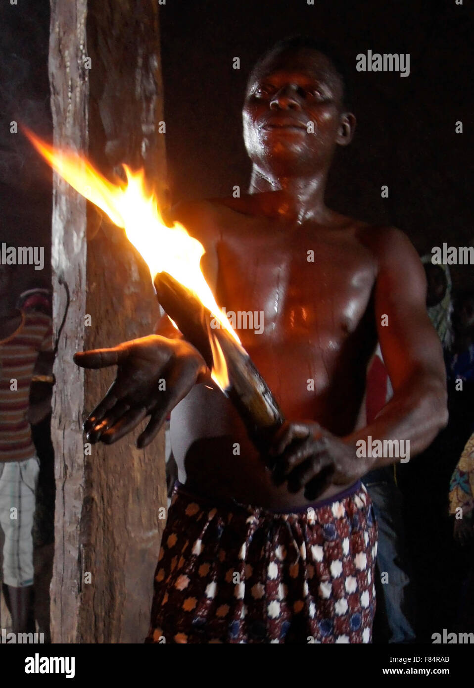 Man burning arm at Bassare T'Bol fire dance, Sokodé, Togo Stock Photo