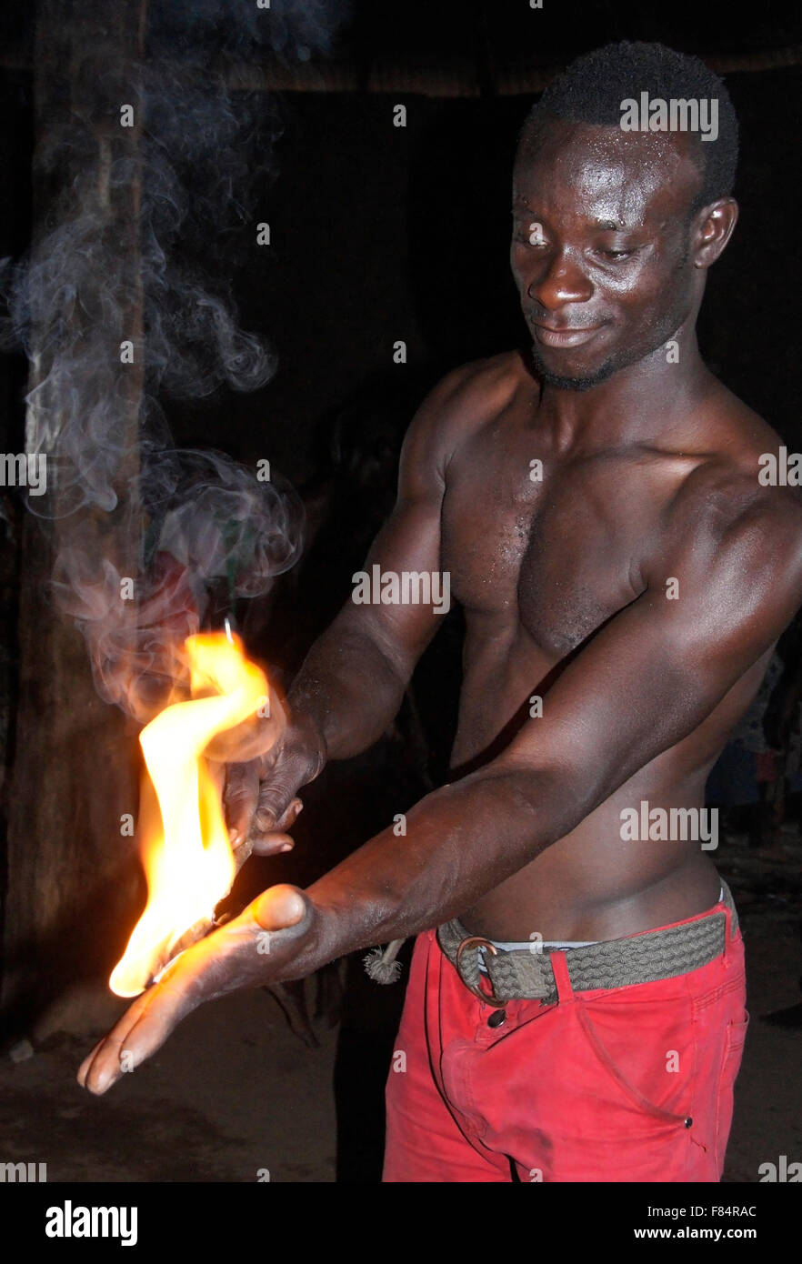 Man burning hand at Bassare T'Bol fire dance, Sokodé, Togo Stock Photo