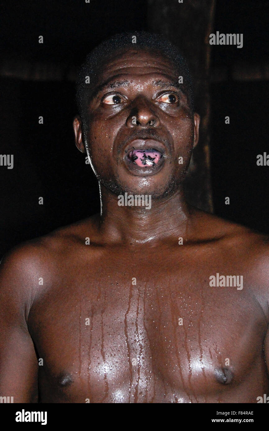 Man chewing razor blades at Bassare T'Bol fire dance, Sokodé, Togo Stock Photo