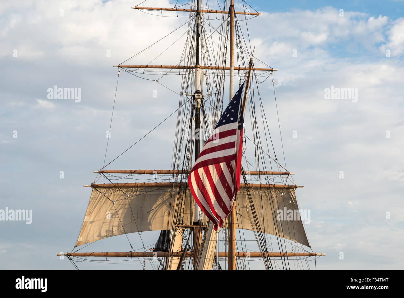 Large sized American Flag with boat mast and rigging. This is ship is called the Star Of India a tourist attraction. San Diego, California, USA. Stock Photo