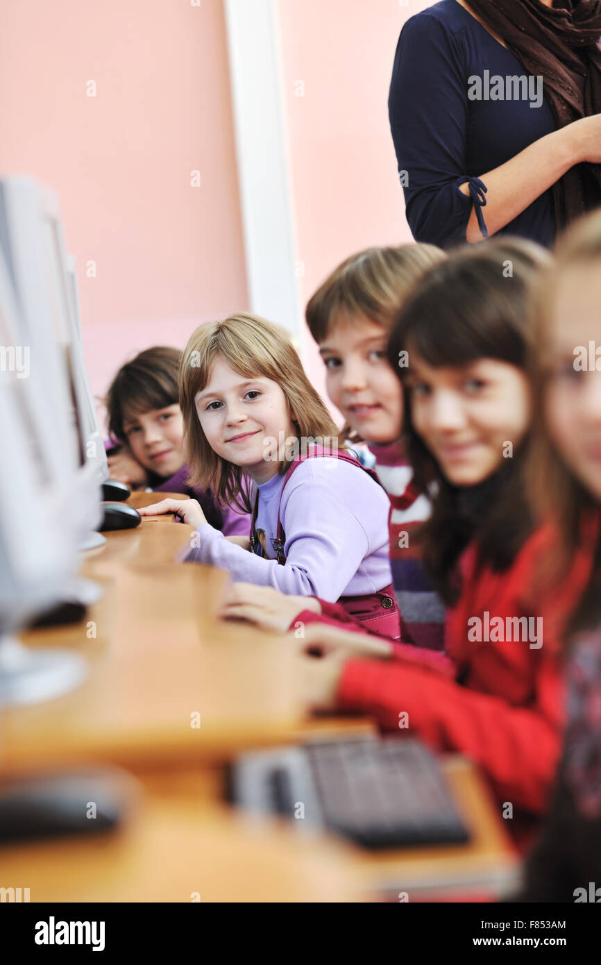 it education with children group in school at computer science class ...