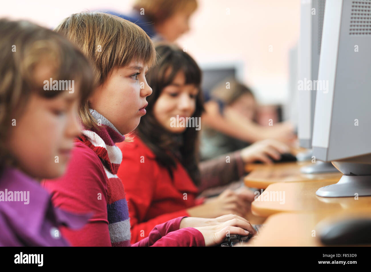 it education with children group in school at computer science class ...