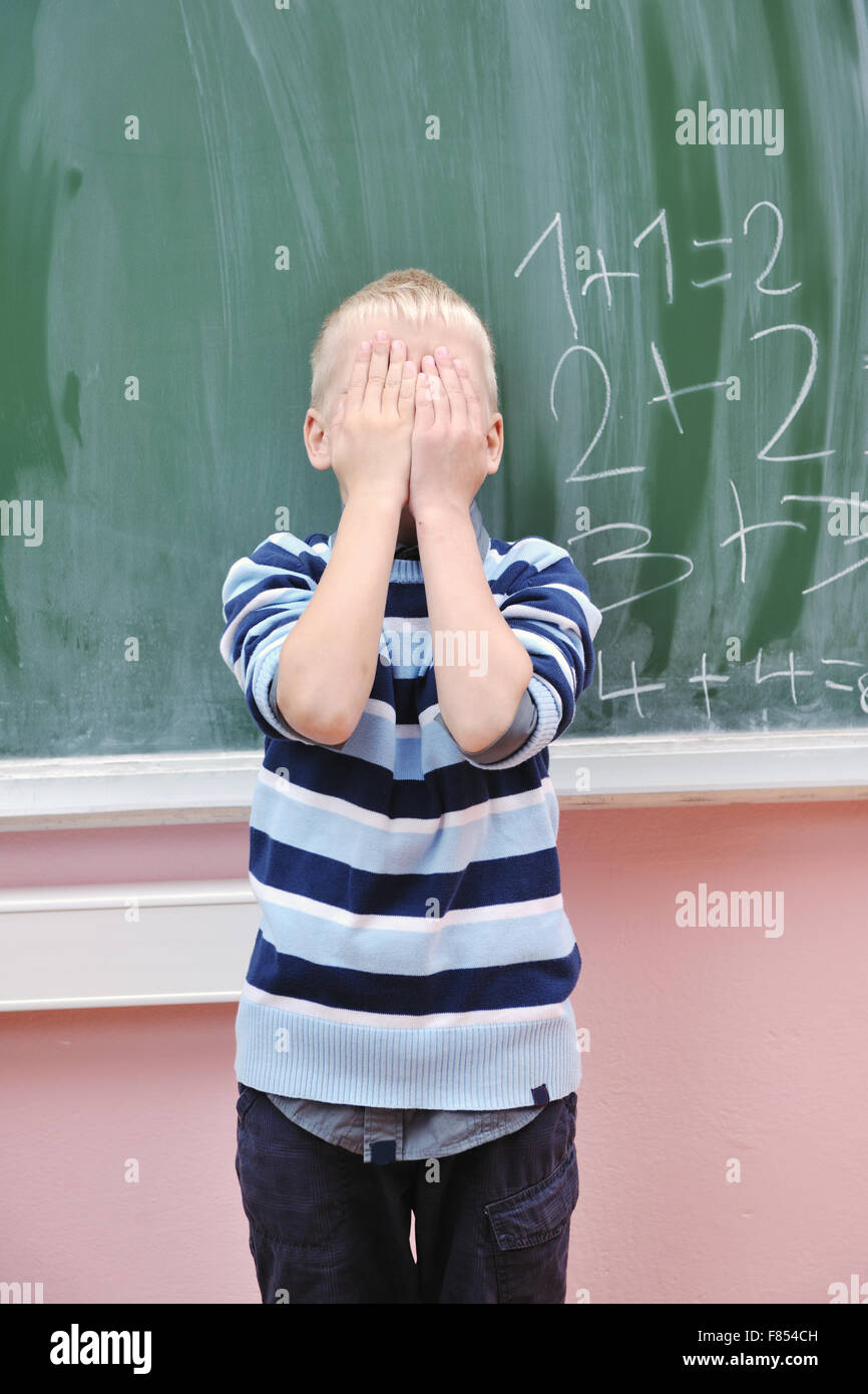 happy young boy at first grade math classes solving problems and ...