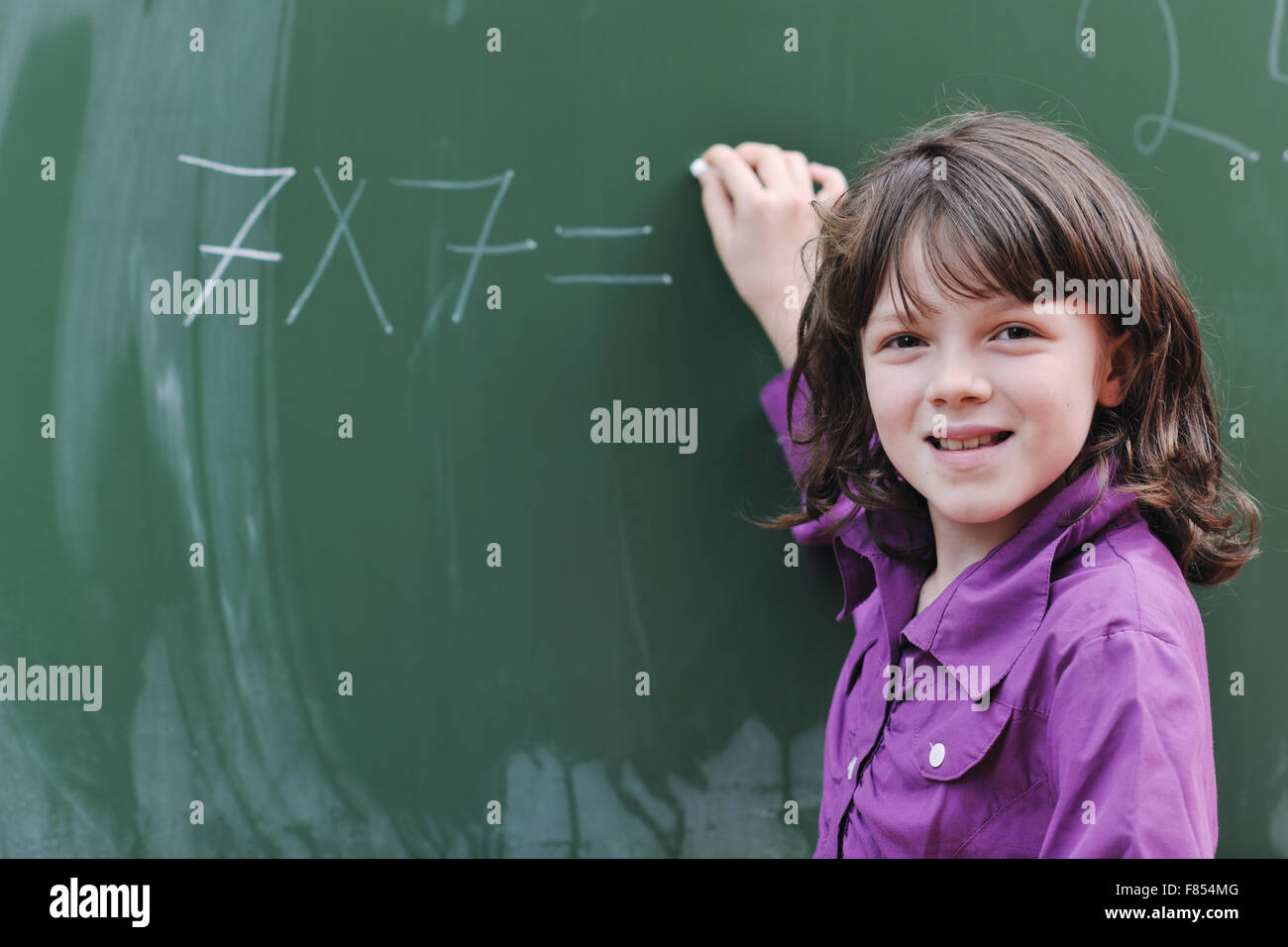 happy school girl on math classes finding solution and solving problems ...