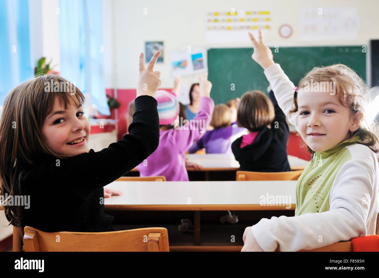 happy young teacher woman at elementrary school teaching and giving ...