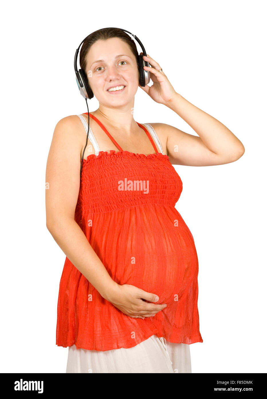 Happy pregnant woman listening to music on white backgroung Stock Photo ...