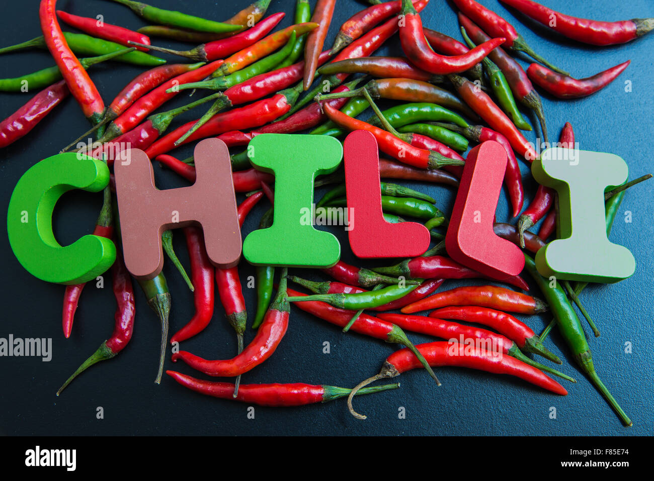 Chilli wooden word on chilli pepper Stock Photo Alamy