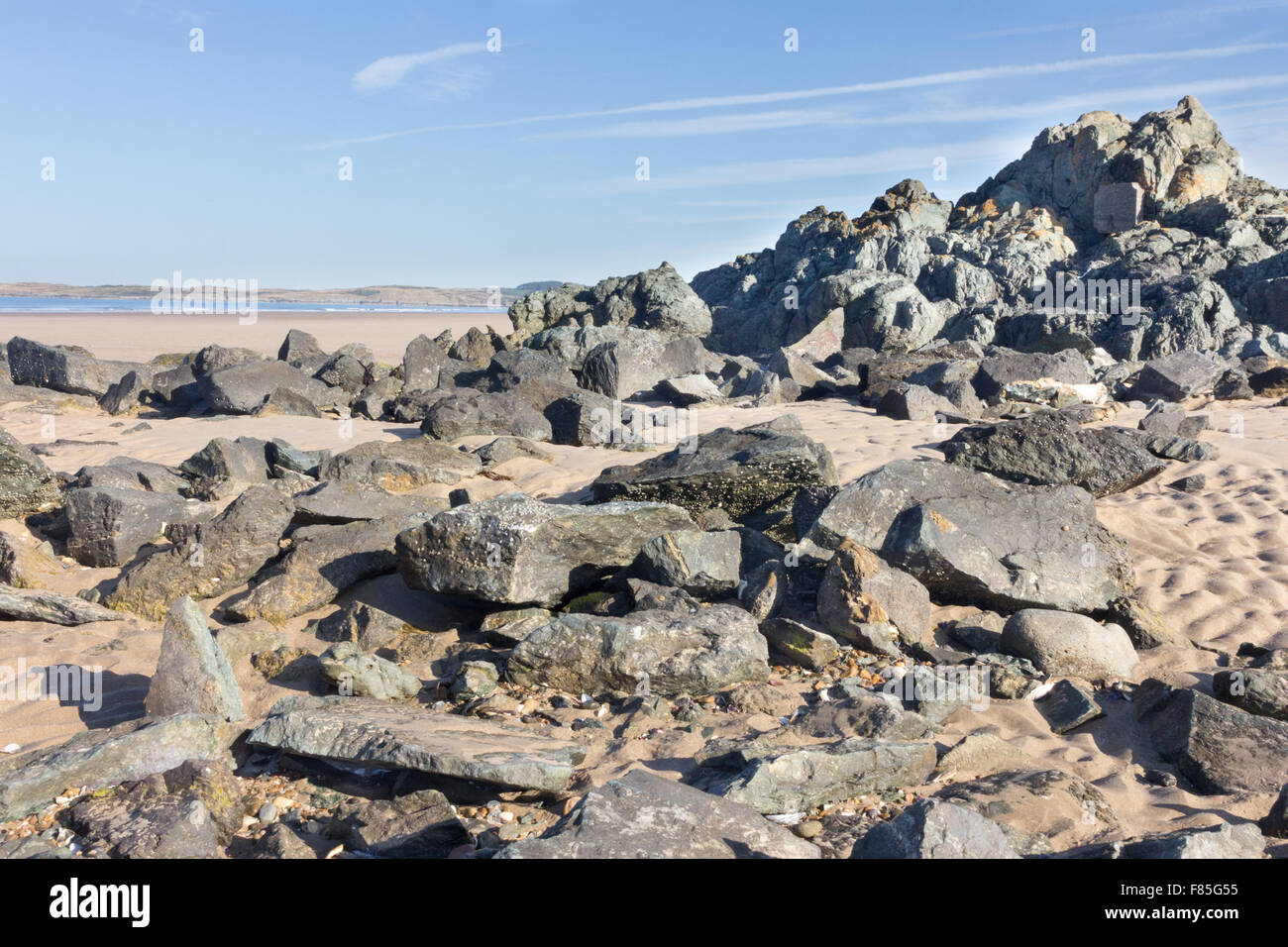 Volcanic rocks on Newborough Beach, Anglesey, Wales Stock Photo Alamy