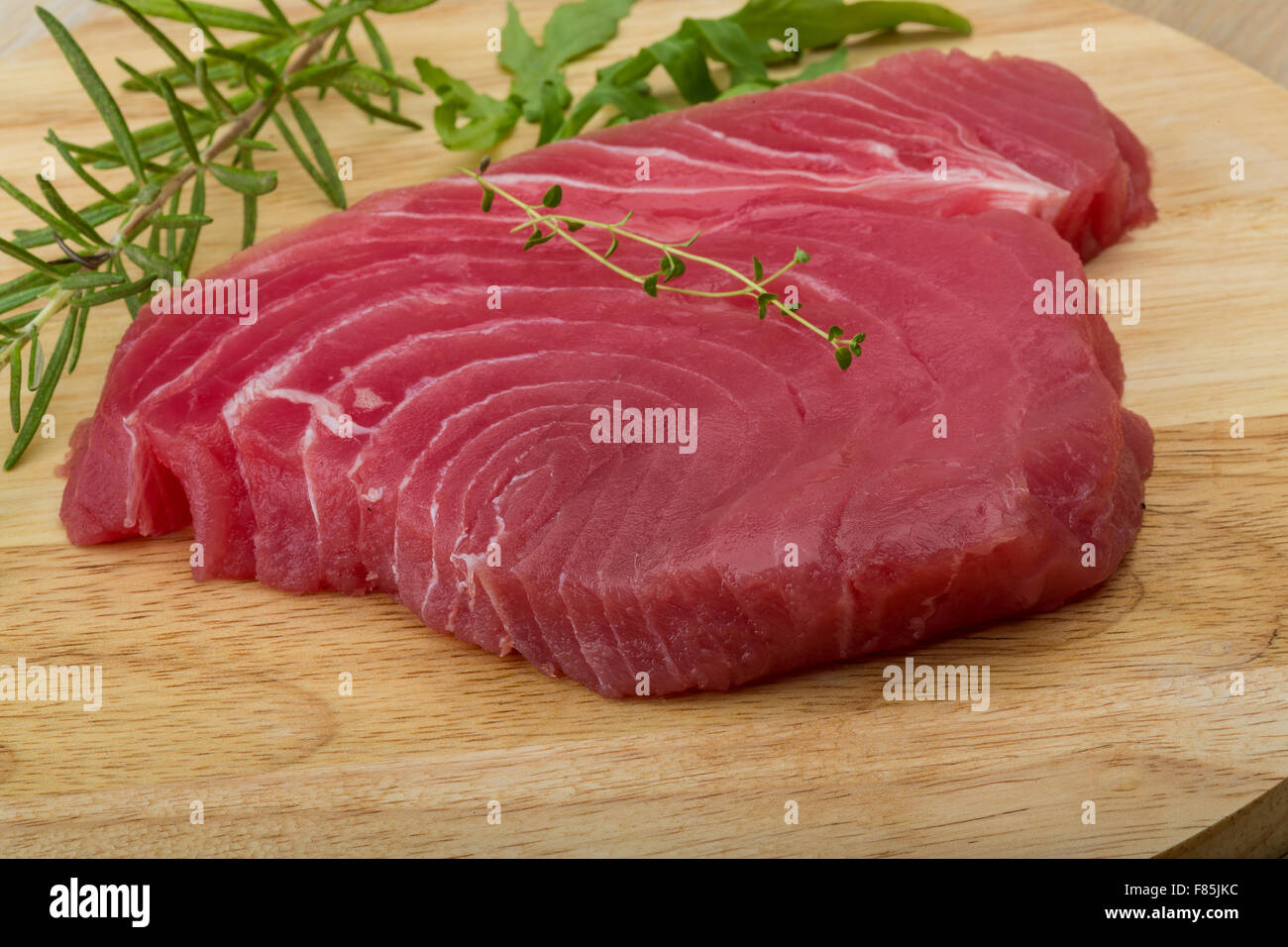 Raw tuna steak with rosemary and thyme Stock Photo Alamy