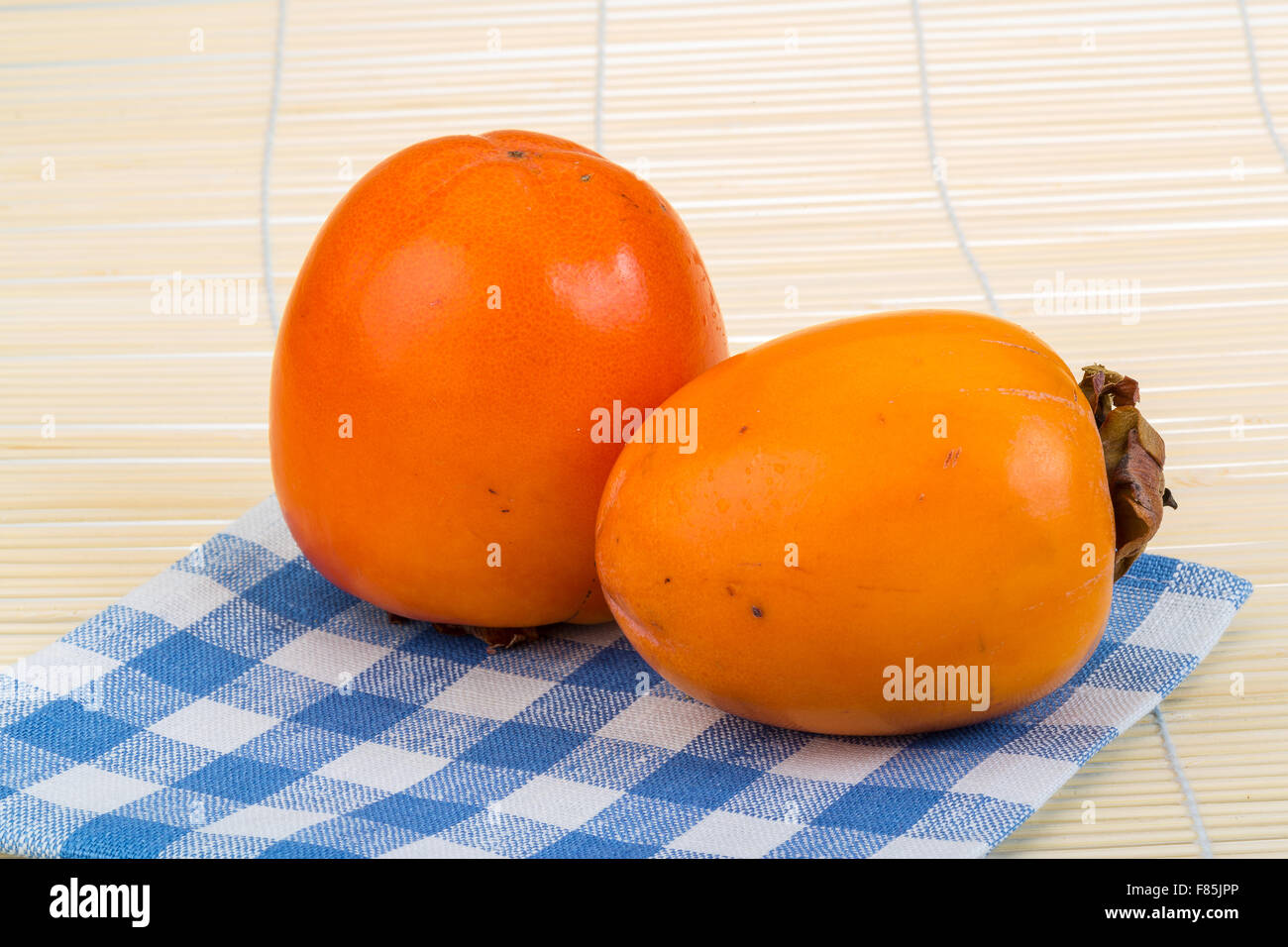 Fresh ripe Persimmon on the wood background Stock Photo - Alamy