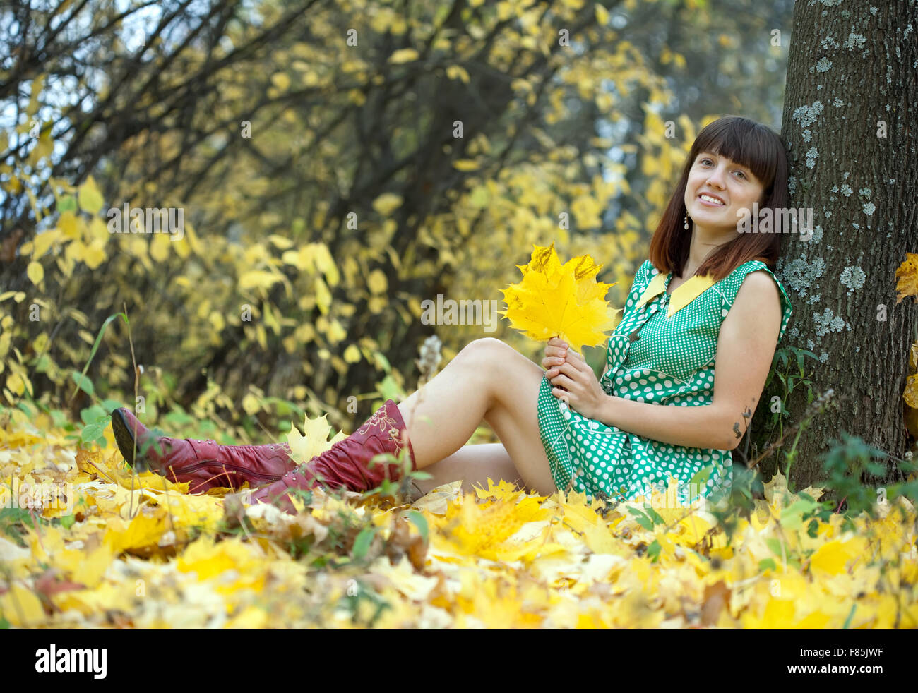 Girl in green dress at autumn park Stock Photo - Alamy