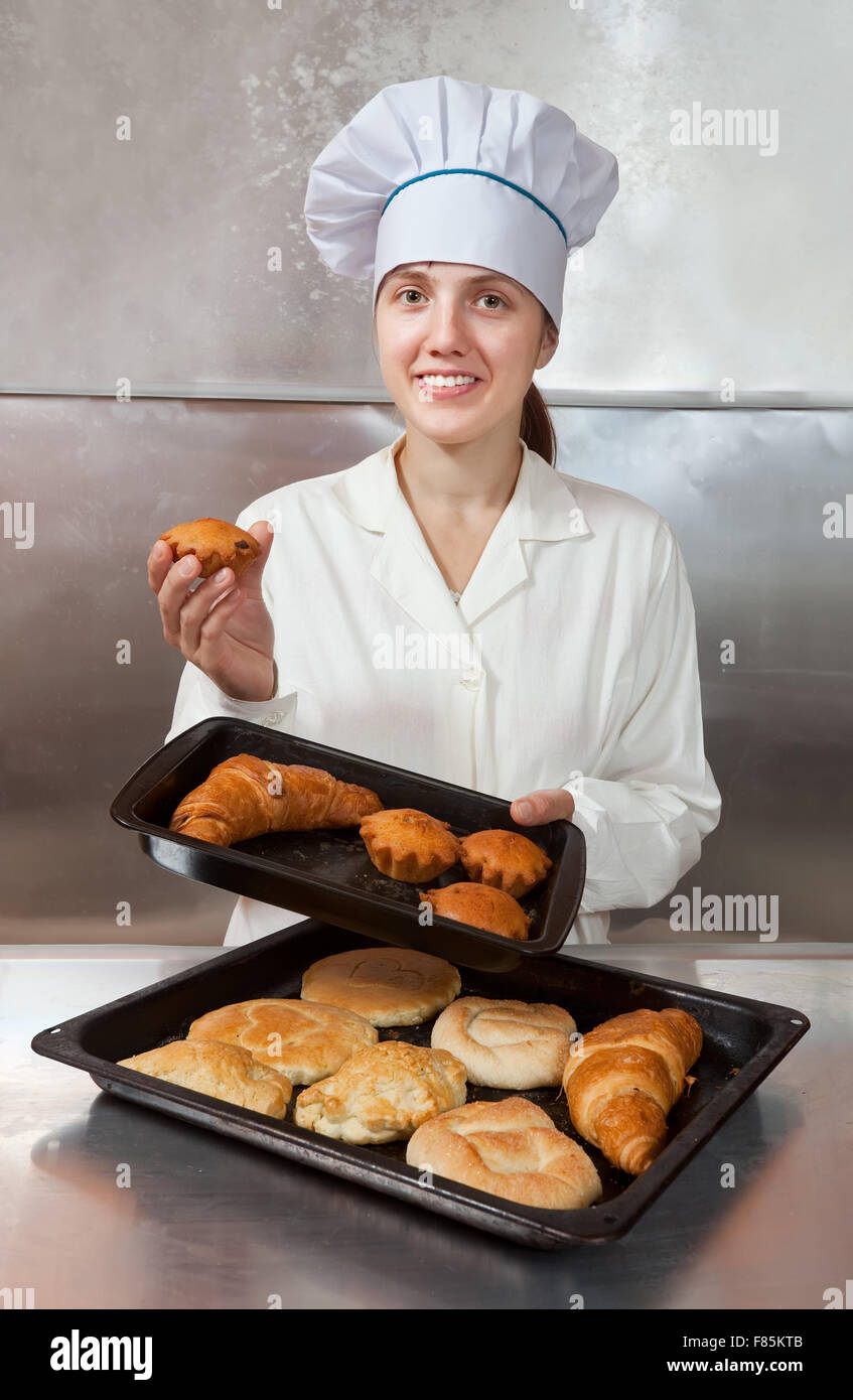 Baker with fresh bake on trays Stock Photo - Alamy