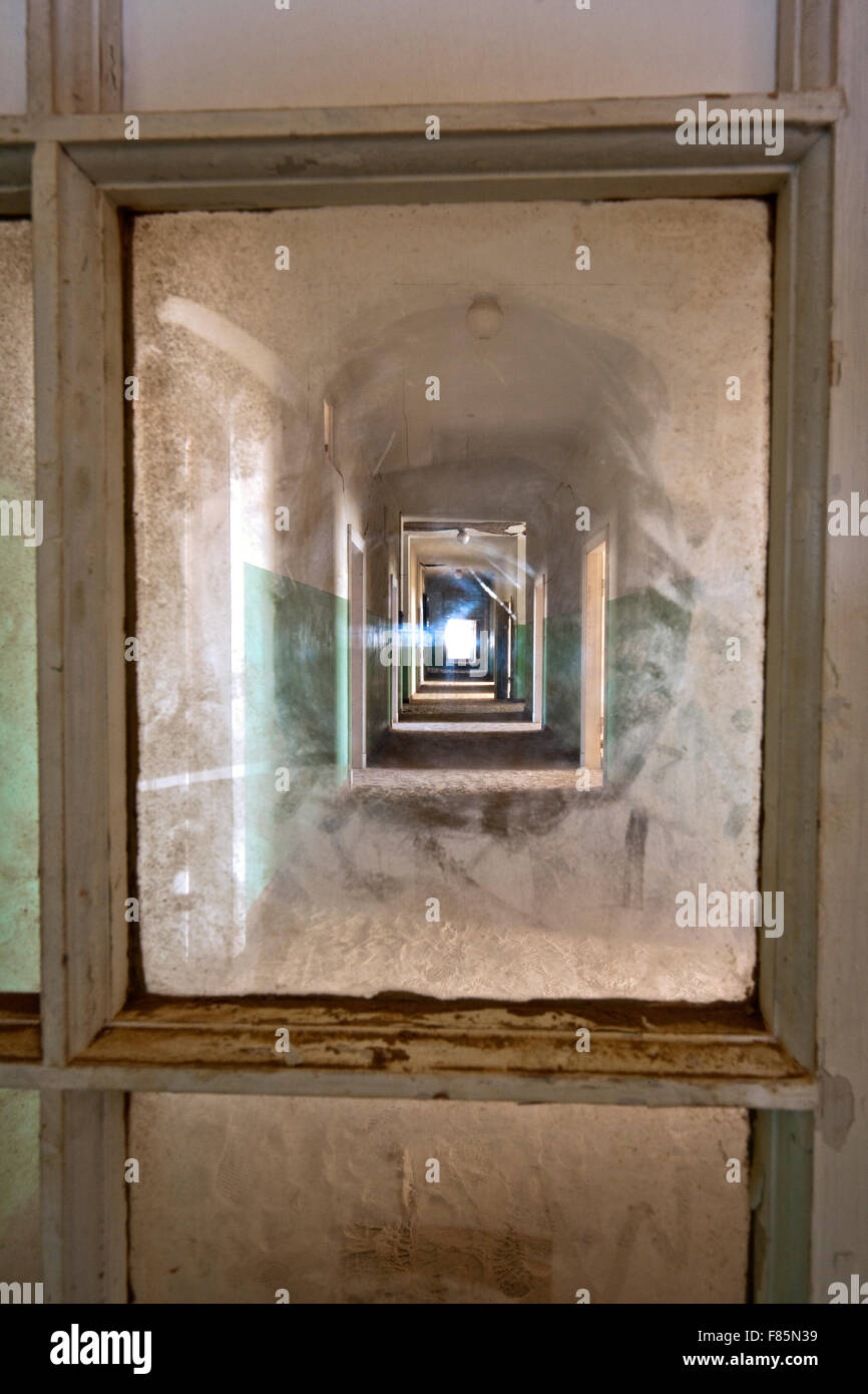 Window Framing Hospital Corridor in Kolmanskop Ghost Town - Luderitz, Namibia, Africa Stock Photo