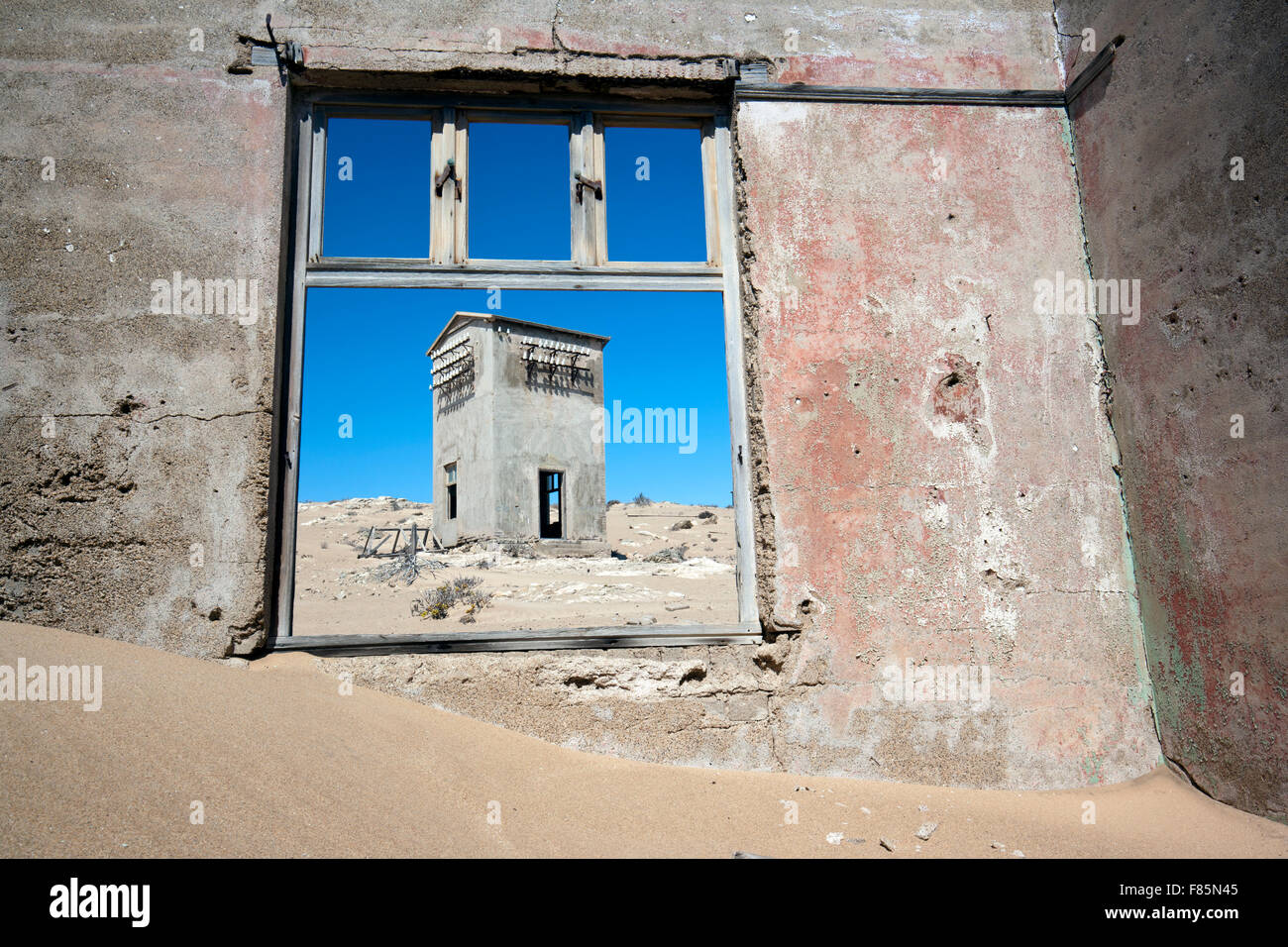 Window framing ruins in Kolmanskop Ghost Town - Luderitz, Namibia, Africa Stock Photo