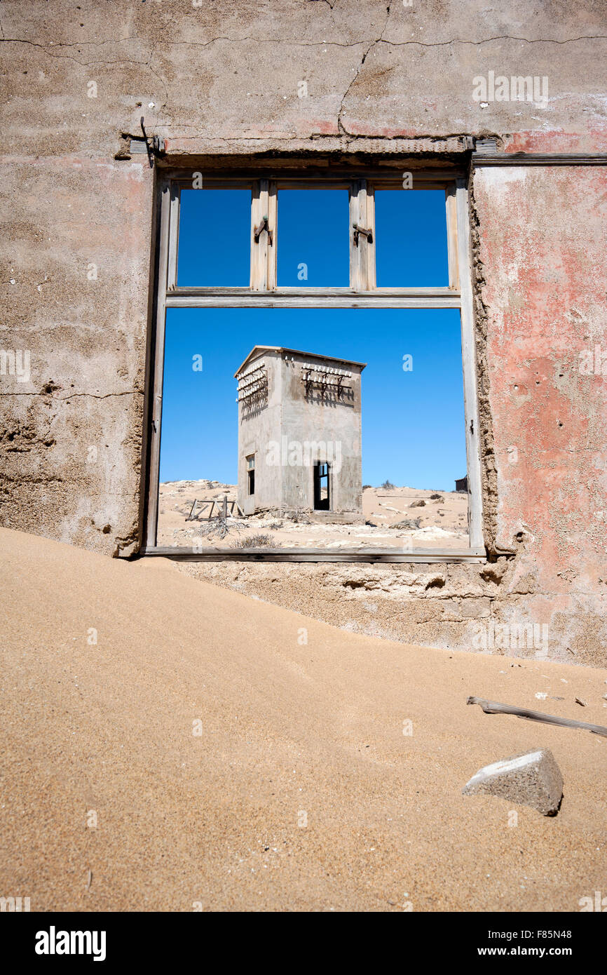 Window framing ruins in Kolmanskop Ghost Town - Luderitz, Namibia, Africa Stock Photo