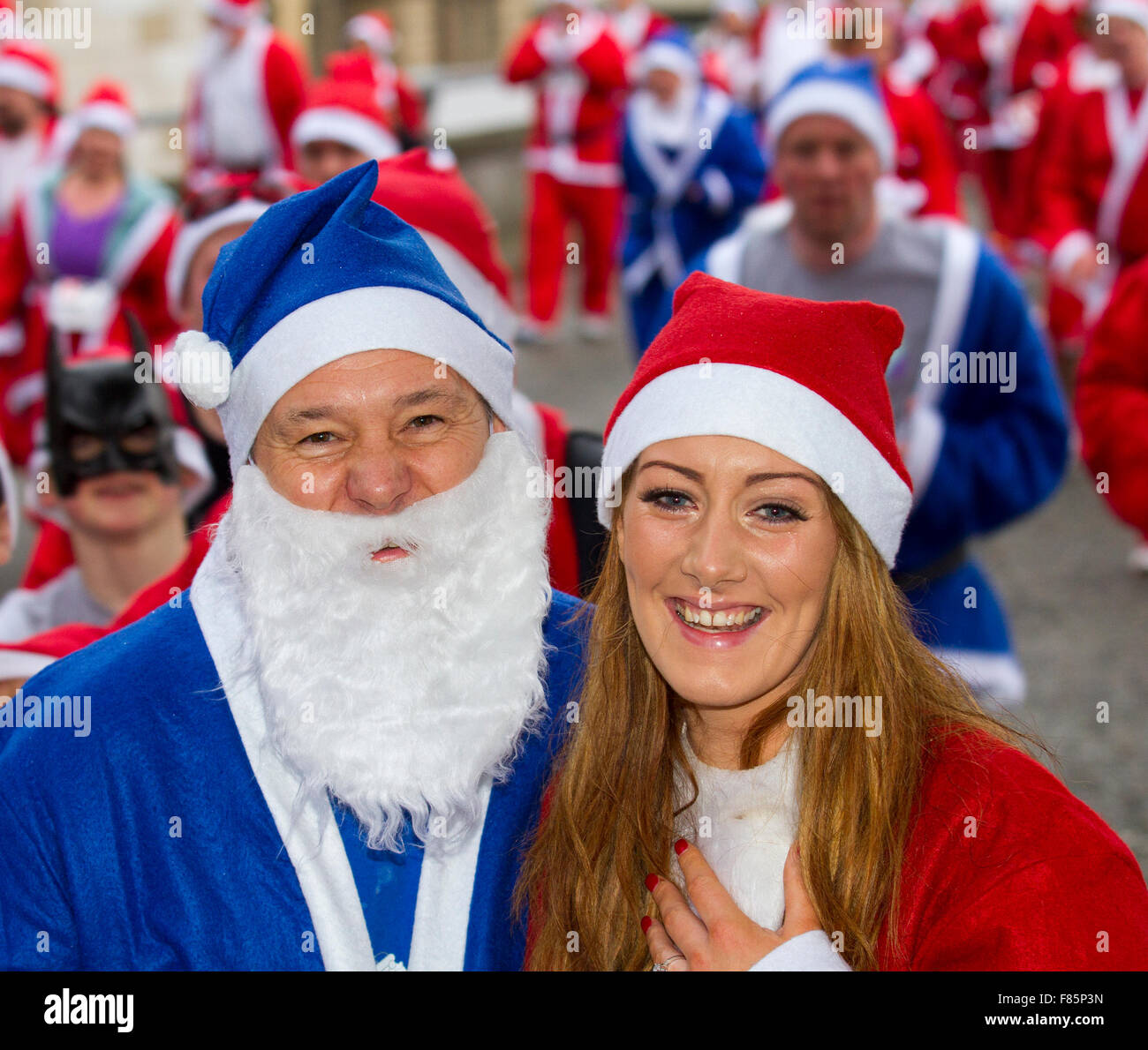 Liverpool, Merseyside, UK  6th December, 2015. A very happy Brian Kempson after his girlfriend, Leila Kelley from Halewood, accepts his marriage proposal.  Brian proposed down on one knee as the Liverpool Santa Dash ran down Churchill Way. His romantic gesture was greeted by cheers from the thousands of runners.  The Medicash Santa Dash course starts and finishes in Liverpool city centre with a 5K route beginning at the Pier Head on Canada Boulevard in front of the Liver Buildings. It finishes in front of the Town Hall at Castle Street.  Credit:  Mar Photographics/Alamy Live News Stock Photo