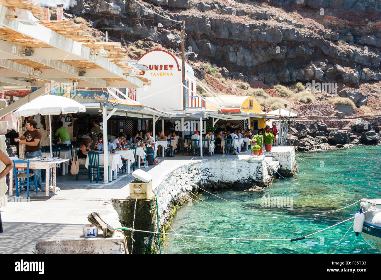 Santorini, Ammoudi beach. Busy 'Sunset' taverna, restaurant, filled
