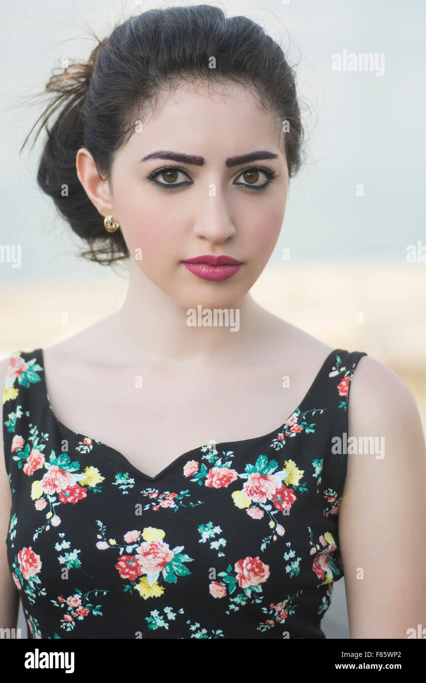 Serious young woman staring outdoors Stock Photo
