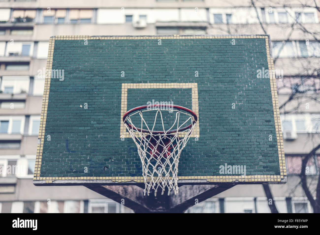 Basketball hoop with backboard in residential district for street basketball game, outdoors sports and recreation, urban environ Stock Photo