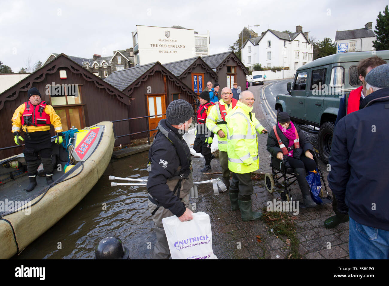 Lake Windermere, Cumbria, UK. 6th Dec, 2015. Severe flood. Lake Windermere flooded over to record high -for a few hours above the previous record  Bowness Bay Sunday morning promenade and main road flooded. Windermere Lake Cruises &  Lake Warden rescue elderly lady stuck at Royal Grange on Lake Windermere who has cancer is is running out of drugs & needs to be in hospital a Newcastle this afternoon Credit:  Gordon Shoosmith/Alamy Live News Stock Photo