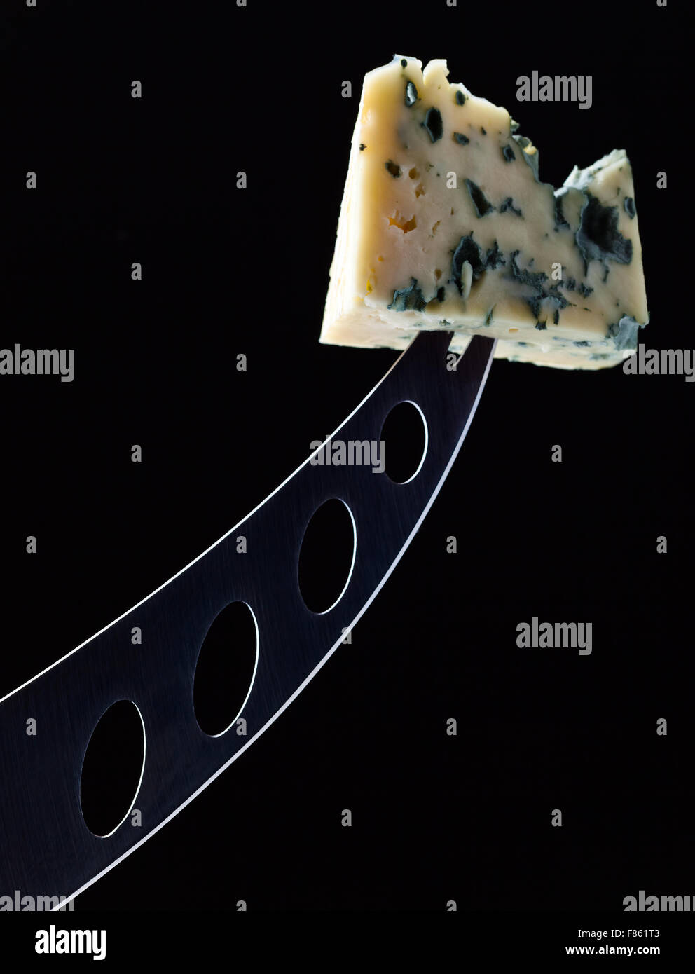 cheese and knife on a black background Stock Photo Alamy
